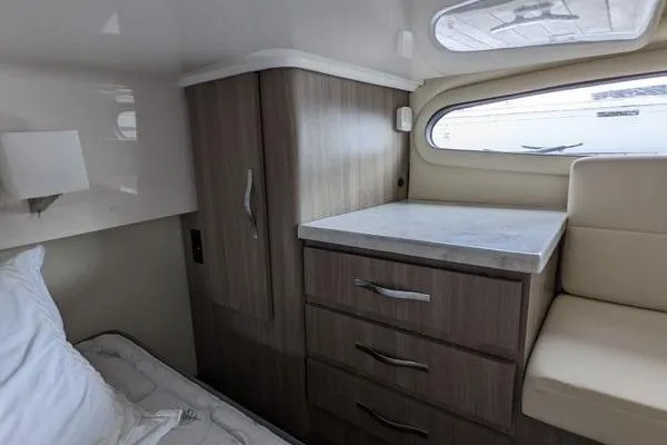  Yacht Photos Pics 2021 Regal 38 XO cabin interior with wood cabinetry and window view.