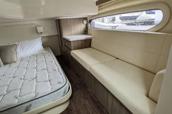  Yacht Photos Pics 2021 Regal 38 XO cabin interior with bed, sofa, and window view.