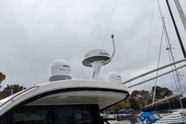  Yacht Photos Pics 2021 Regal 38 XO yacht with Garmin radar and domes, docked in a marina.