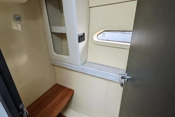  Yacht Photos Pics 2021 Regal 38 XO interior cabin with wooden bench and window.