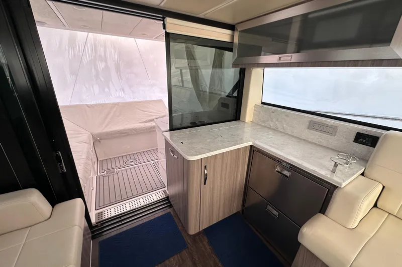  Yacht Photos Pics 2021 Regal 38 XO yacht interior with modern kitchen and seating area.