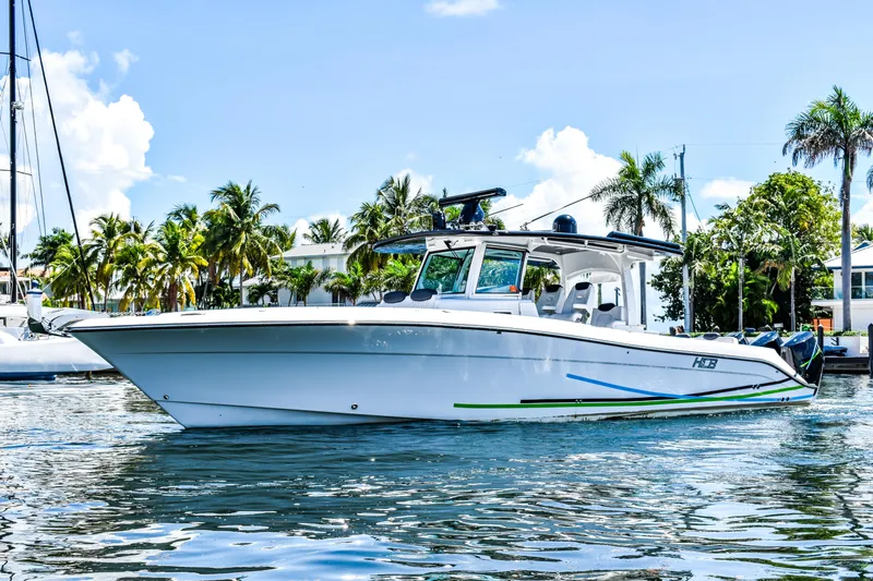 Water Bird Yacht Photos Pics 2025 HCB 42 Lujo boat on water, surrounded by palm trees and clear skies.