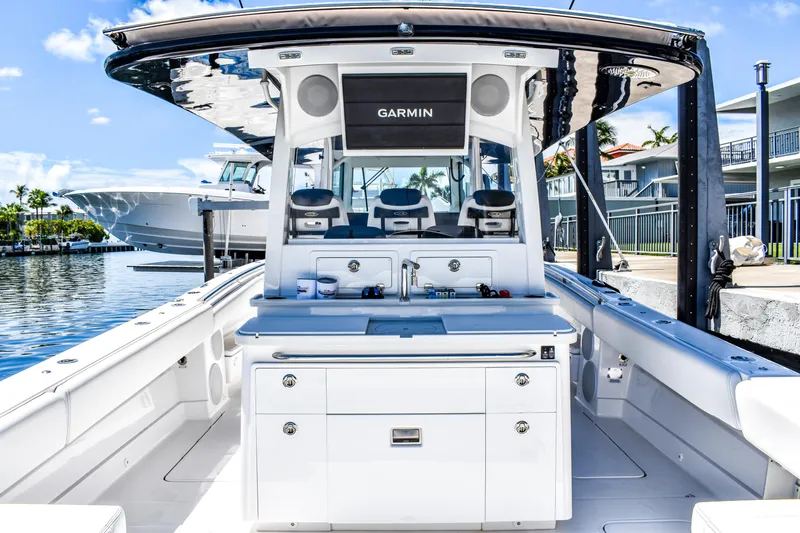 Water Bird Yacht Photos Pics 2025 HCB 42 Lujo boat interior with Garmin equipment, docked by waterfront homes.