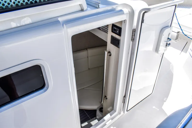 Water Bird Yacht Photos Pics 2025 HCB 42 Lujo boat cabin entrance with sleek white interior design.