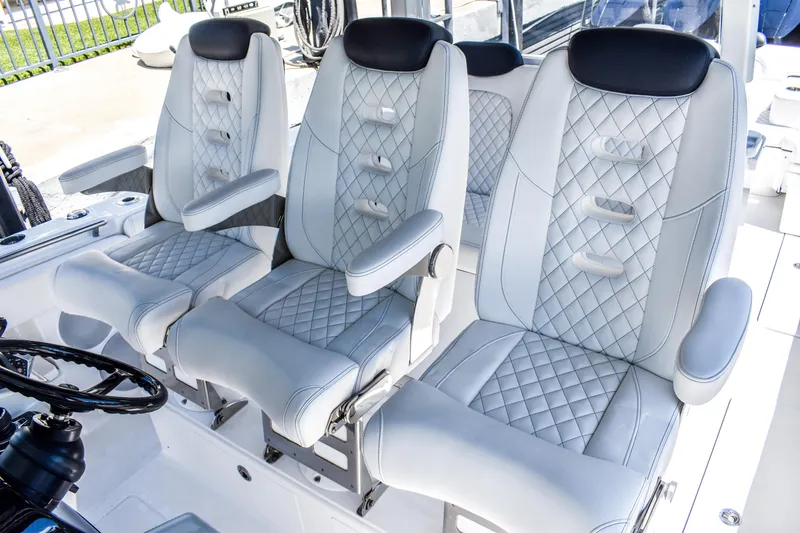 Water Bird Yacht Photos Pics Luxury seating on 2025 HCB 42 Lujo boat, featuring quilted leather design and armrests.