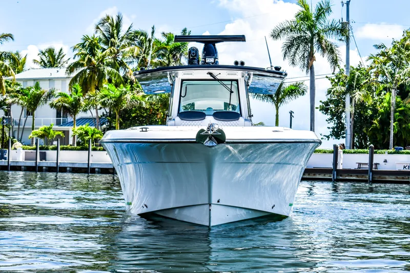 Water Bird Yacht Photos Pics 2025 HCB 42 Lujo boat on water, surrounded by palm trees and waterfront homes.