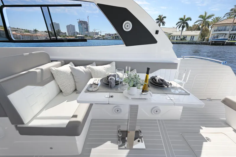  Yacht Photos Pics Luxurious interior of 2025 Valiatt 380 Bowrider yacht with elegant dining setup and waterfront view.