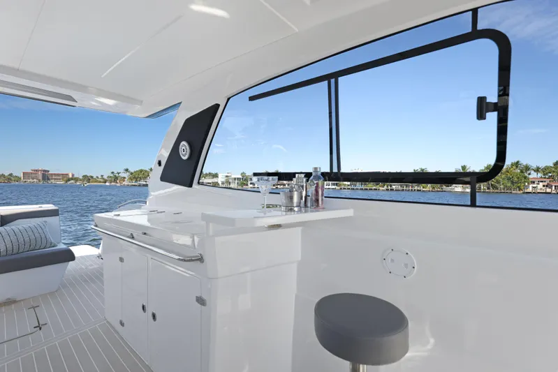  Yacht Photos Pics Interior of 2025 Valiatt 380 Bowrider yacht with bar and seating, overlooking water.