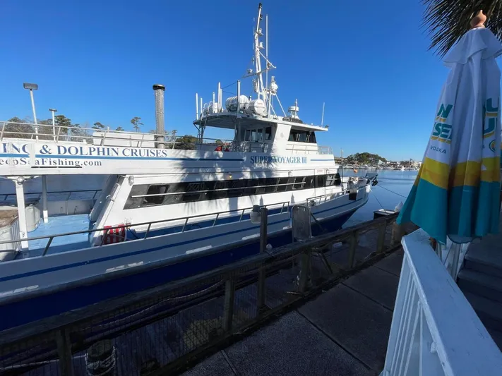 Super Voyager III Yacht Photos Pics 1972 Swiftships Commercial Passenger boat docked, offering scenic and dolphin cruises.