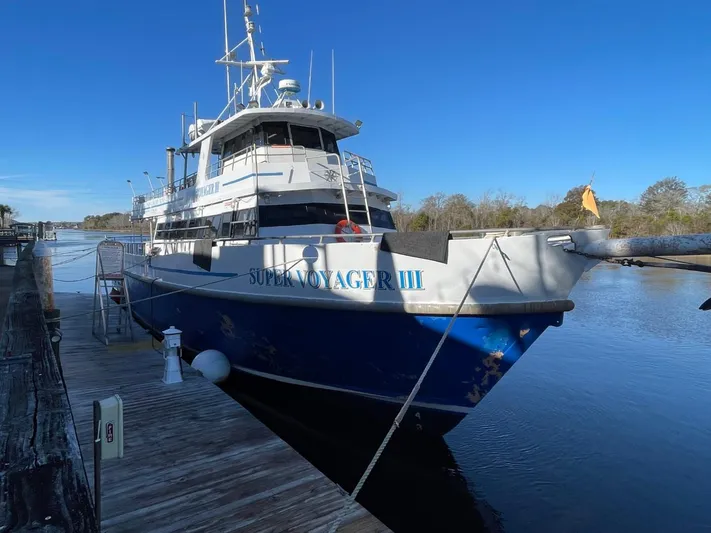 Super Voyager III Yacht Photos Pics Swiftships 1972 Commercial Passenger vessel docked, named "Super Voyager III," under clear blue skies.