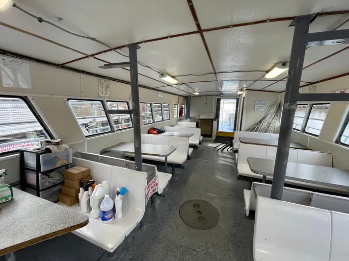 Super Voyager III Yacht Photos Pics Interior of a 1972 Swiftships commercial passenger vessel with seating and supplies.