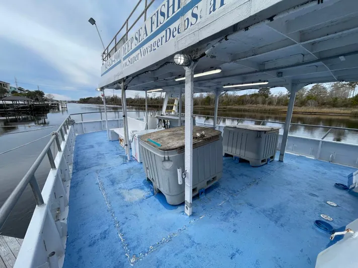Super Voyager III Yacht Photos Pics 1972 Swiftships Commercial Passenger boat with blue deck, docked by a calm river.