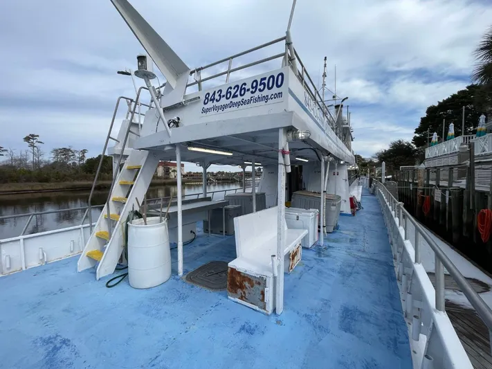 Super Voyager III Yacht Photos Pics 1972 Swiftships commercial passenger boat docked, featuring blue deck and upper seating area.