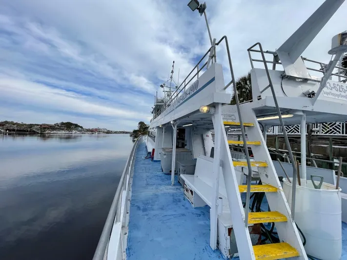 Super Voyager III Yacht Photos Pics 1972 Swiftships Commercial Passenger boat docked by calm waters under a cloudy sky.
