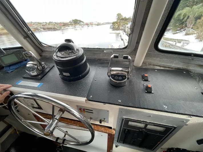 Super Voyager III Yacht Photos Pics Interior view of a 1972 Swiftships Commercial Passenger boat cockpit with steering wheel and controls.