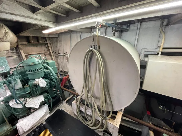 Super Voyager III Yacht Photos Pics Engine room of 1972 Swiftships commercial passenger vessel with water tank and machinery.