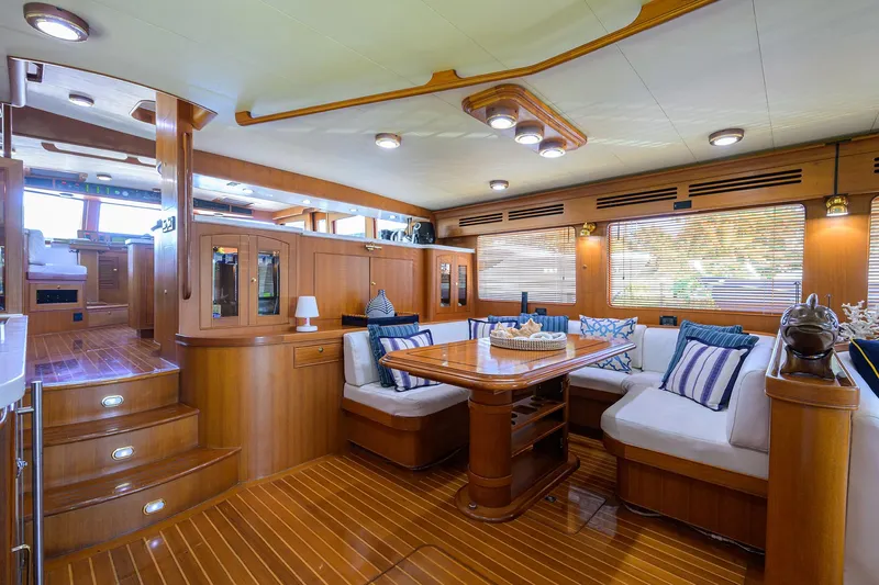 Bandol Yacht Photos Pics Luxurious interior of 2006 Marlow 78E yacht with elegant wood finish and cozy seating.