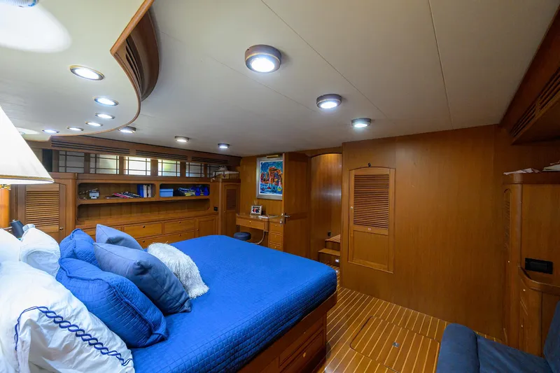 Bandol Yacht Photos Pics Luxurious Marlow 78E yacht bedroom with wood paneling and blue bedding, 2006 model.