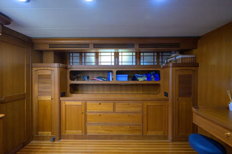 Bandol Yacht Photos Pics Wooden interior of 2006 Marlow 78E yacht with built-in storage and shelving.