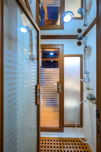 Bandol Yacht Photos Pics Luxurious Marlow 78E 2006 yacht shower with wood accents and modern fixtures.