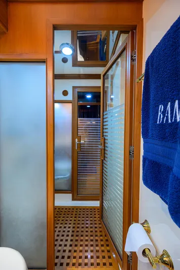 Bandol Yacht Photos Pics Luxurious Marlow 78E 2006 yacht bathroom with wooden accents and frosted glass doors.