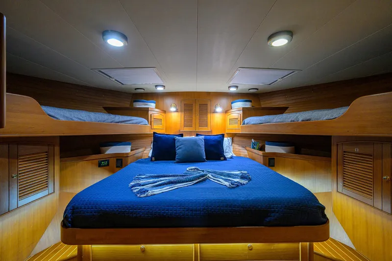 Bandol Yacht Photos Pics Luxurious cabin interior of 2006 Marlow 78E yacht with cozy bedding and ambient lighting.