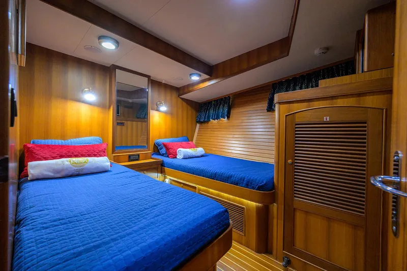 Bandol Yacht Photos Pics Luxurious 2006 Marlow 78E yacht cabin with twin beds and wooden interior.