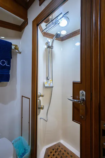 Bandol Yacht Photos Pics Luxurious shower in 2006 Marlow 78E yacht with wooden accents and modern fixtures.
