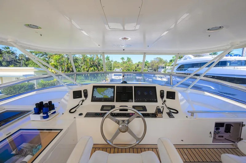 Bandol Yacht Photos Pics Interior view of 2006 Marlow 78E yacht helm with navigation screens and steering wheel.