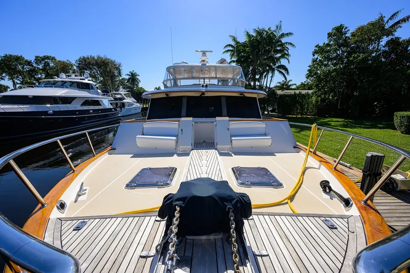 Bandol Yacht Photos Pics Marlow 78E yacht, 2006 model, docked with clear sky and lush greenery.
