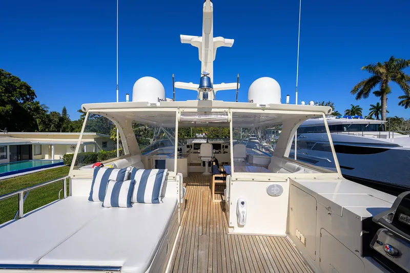 Bandol Yacht Photos Pics Luxurious 2006 Marlow 78E yacht deck with seating, blue sky, and palm trees.