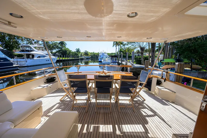Bandol Yacht Photos Pics Spacious deck of 2006 Marlow 78E yacht with elegant seating and scenic marina view.