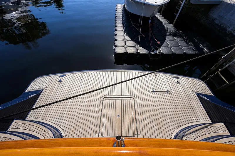 Bandol Yacht Photos Pics Marlow 78E yacht stern view, docked, showcasing teak deck, 2006 model.