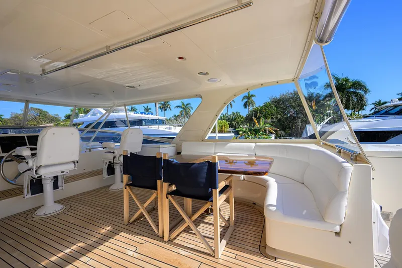 Bandol Yacht Photos Pics Luxurious 2006 Marlow 78E yacht deck with seating and table, surrounded by palm trees.