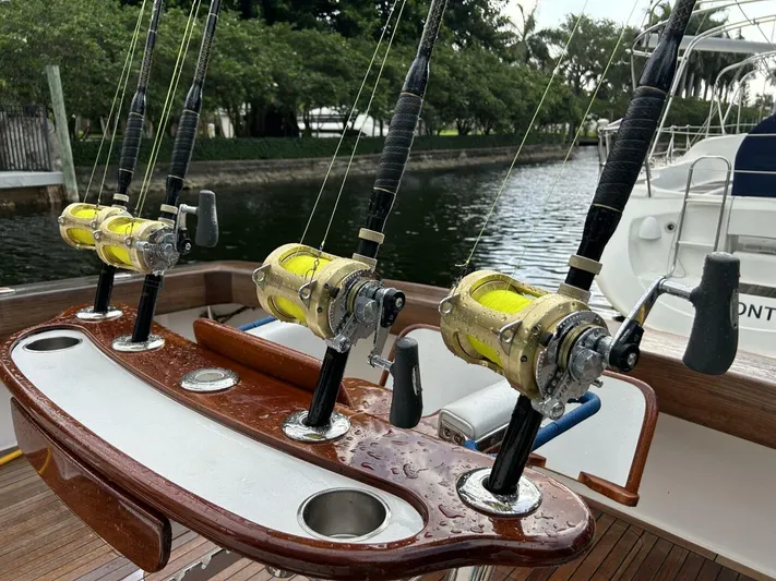Rusty Yacht Photos Pics Fishing rods on a 2006 Viking 52 Convertible boat, docked by a lush canal.