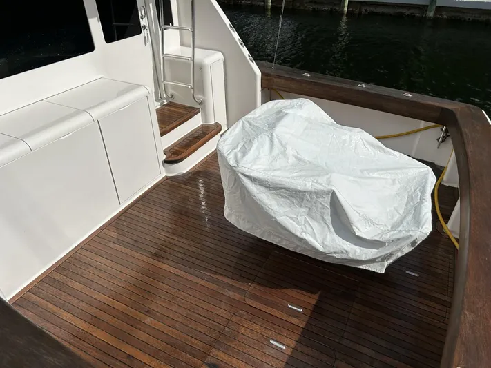 Rusty Yacht Photos Pics 2006 Viking 52 Convertible yacht deck with wooden flooring and covered equipment.