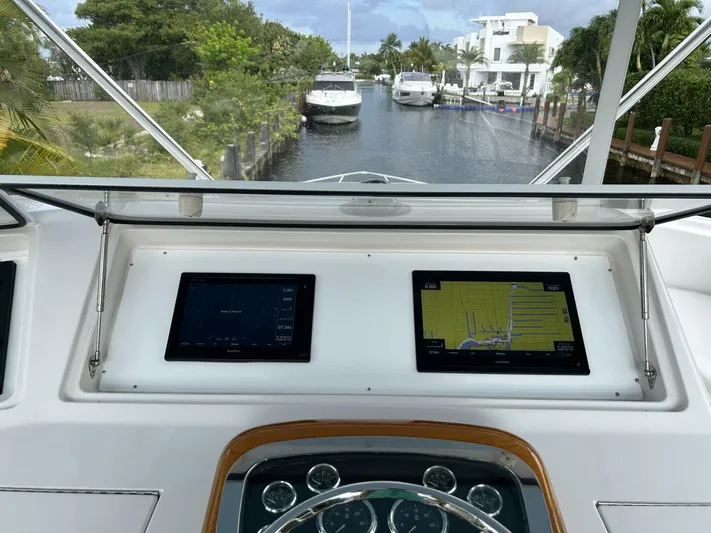 Rusty Yacht Photos Pics Viking 52 Convertible 2006 yacht dashboard with navigation screens, canal view.