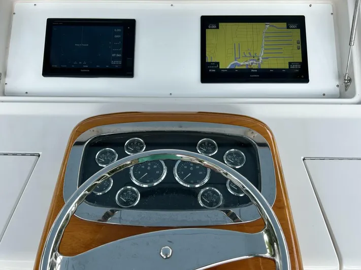 Rusty Yacht Photos Pics Helm of 2006 Viking 52 Convertible with dual Garmin displays and classic gauges.