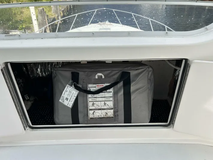 Rusty Yacht Photos Pics Storage compartment on a 2006 Viking 52 Convertible boat with a safety equipment bag.