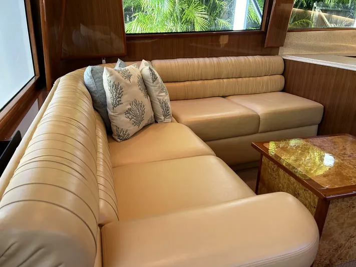 Rusty Yacht Photos Pics Luxurious interior of 2006 Viking 52 Convertible yacht with beige leather seating and decorative pillows.