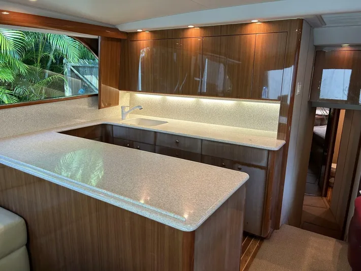 Rusty Yacht Photos Pics Luxurious kitchen interior of 2006 Viking 52 Convertible yacht with wood cabinetry and modern design.