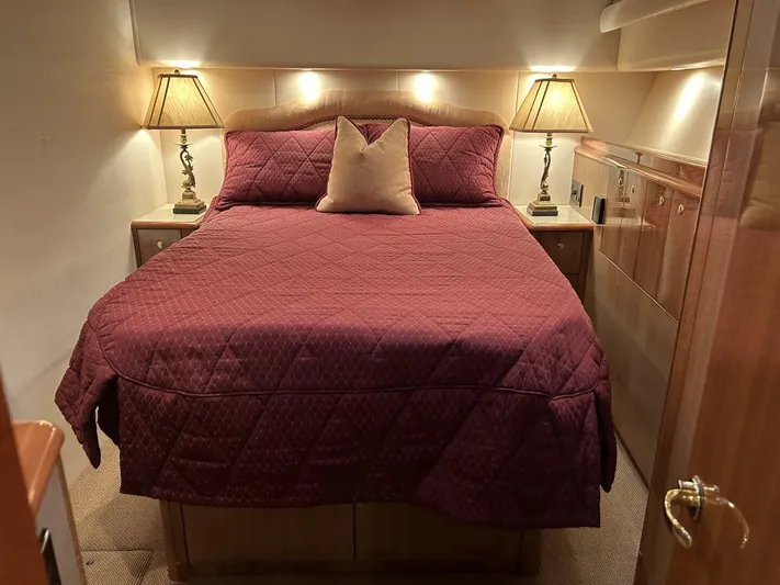 Rusty Yacht Photos Pics Luxurious bedroom interior of 2006 Viking 52 Convertible yacht with elegant bedding and lamps.