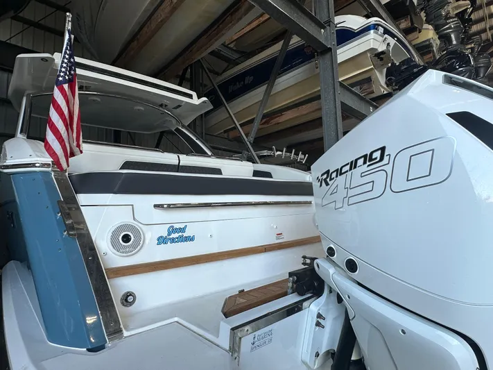  Yacht Photos Pics 2022 Cobalt R33 boat with Racing 450 engine in storage, featuring American flag.