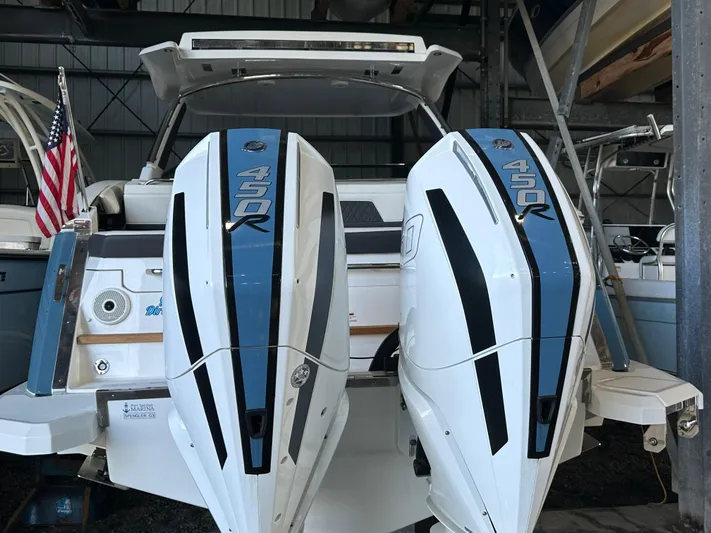  Yacht Photos Pics Cobalt R33 2022 boat with dual 450R outboard engines in a storage facility.