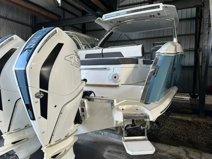  Yacht Photos Pics Cobalt R33 2022 boat with dual outboard engines in a storage facility.