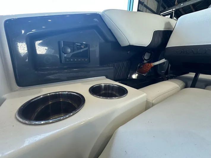  Yacht Photos Pics Interior of 2022 Cobalt R33 boat with cup holders and control panel.
