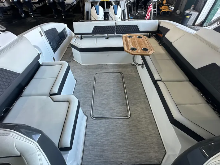  Yacht Photos Pics Luxurious interior of 2022 Cobalt R33 boat with seating and wooden table.