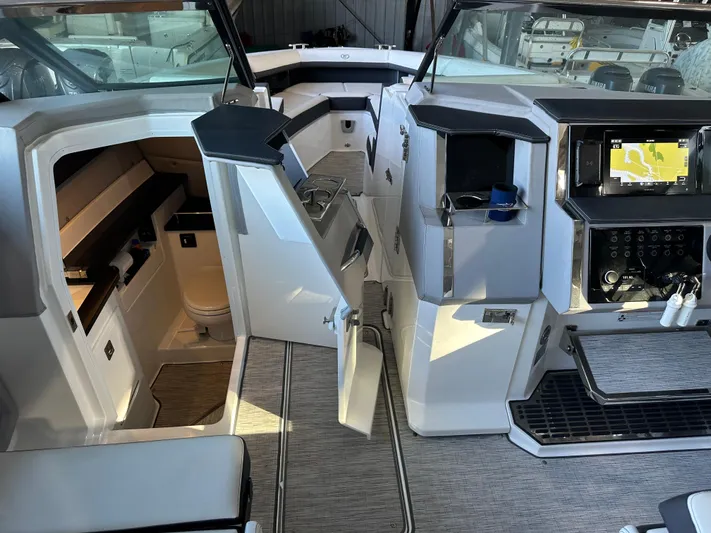  Yacht Photos Pics 2022 Cobalt R33 boat interior with modern dashboard and seating area.