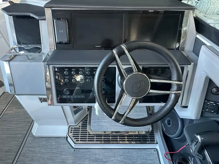  Yacht Photos Pics 2022 Cobalt R33 boat dashboard with steering wheel and control panel.