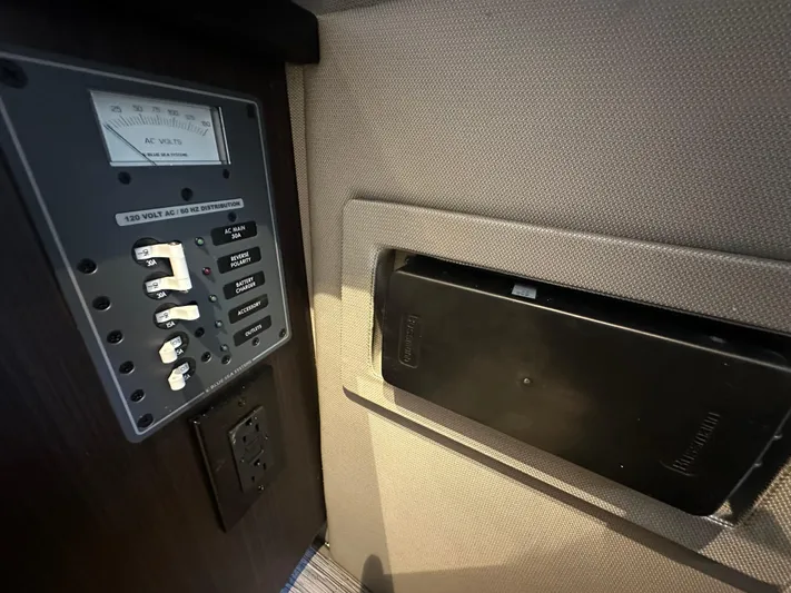  Yacht Photos Pics Control panel and storage compartment in 2022 Cobalt R33 boat interior.